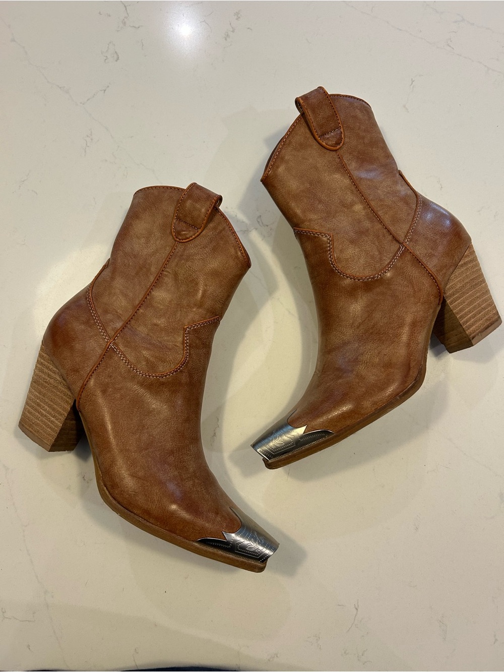 Tan heeled boots. Silver detail on toe. Worn once. From Lulu’s.